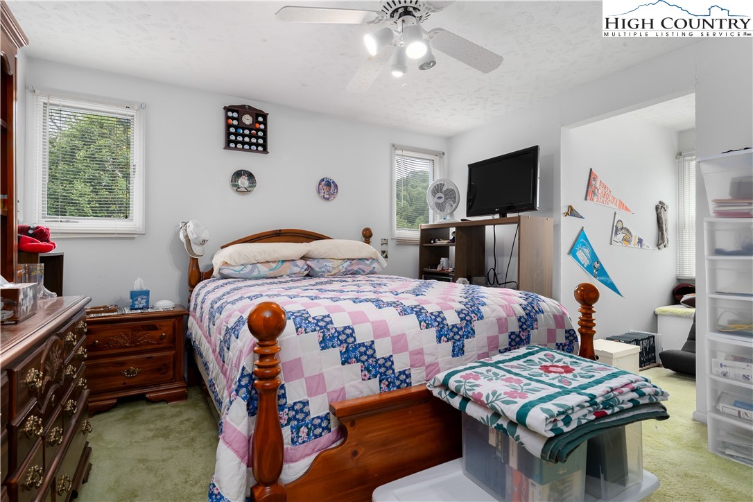 1546 Stage Road Mountain City, TN 37683 - Photo 29 of 48 a bedroom with two beds and a flat screen tv