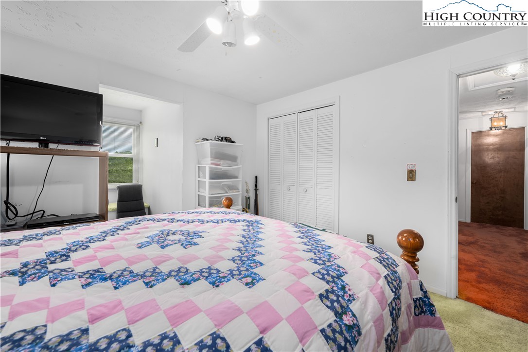 1546 Stage Road Mountain City, TN 37683 - Photo 30 of 48 a bedroom with a bed and a flat screen tv