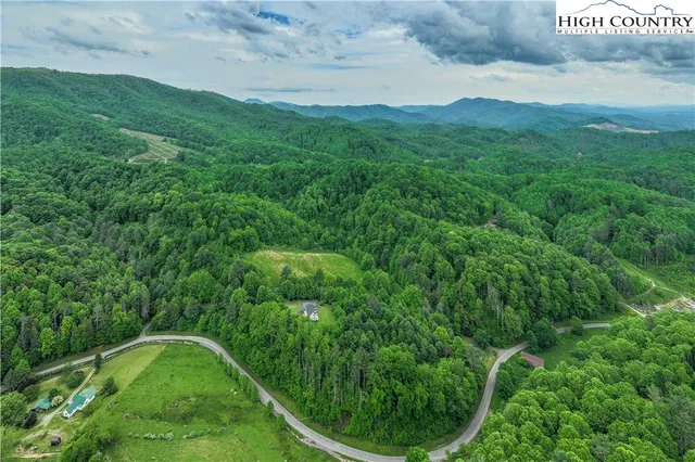 a view of a big yard with lots of green space
