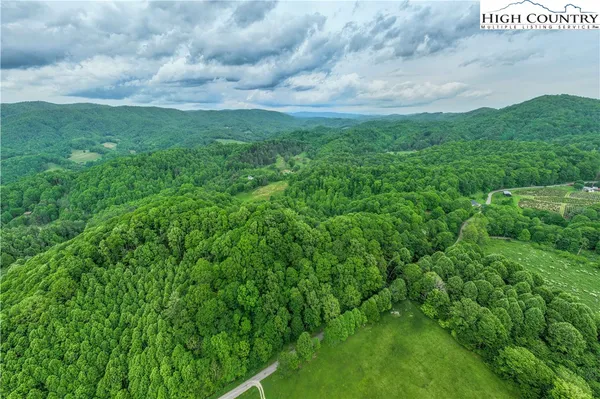 a aerial view of a house with a yard and sitting area