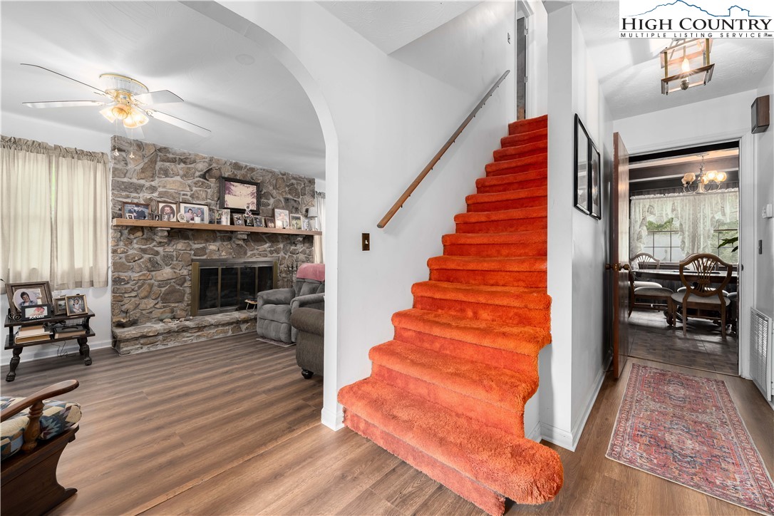 1546 Stage Road Mountain City, TN 37683 - Photo 6 of 48 a view of a livingroom with furniture a fireplace chandeliers and wooden floor