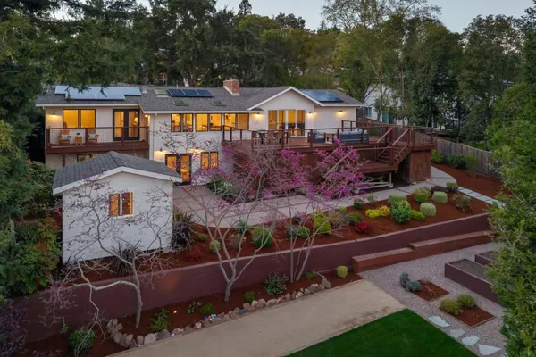 an aerial view of a house with swimming pool and porch