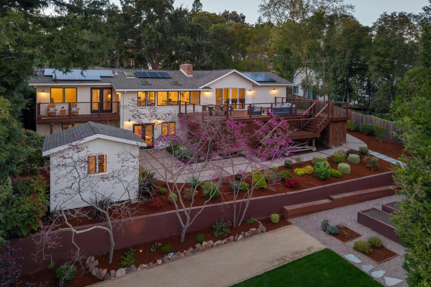 an aerial view of a house with swimming pool and porch