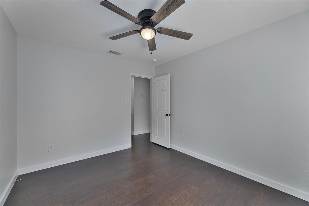 605 Clearbrook Street Azle, TX 76020 - Photo 24 of 33 Room featuring dark wood-finish flooring and light gray walls