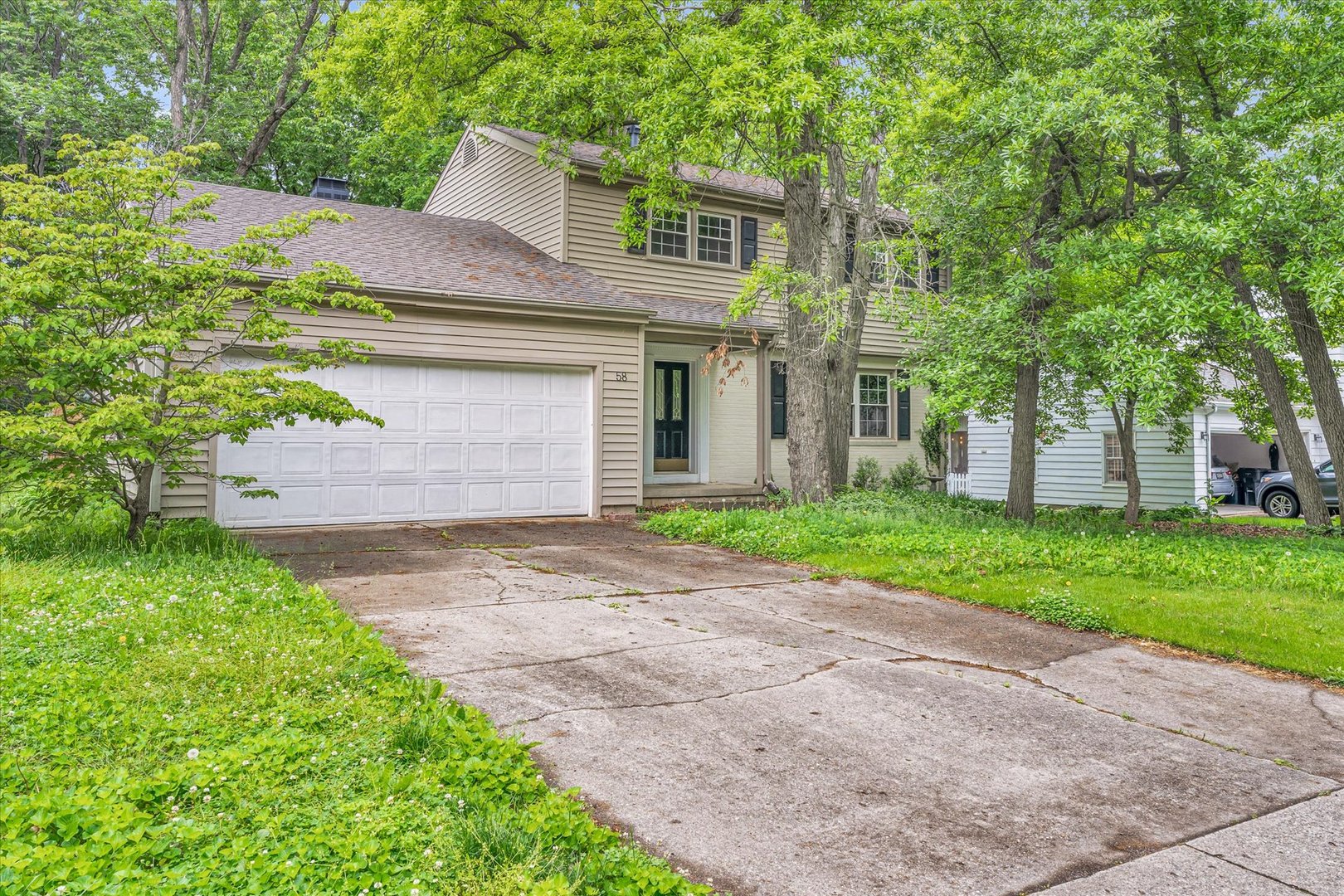 58 Woodhill Court Decatur, IL 62521 - Photo 1 of 29 a front view of a house with a yard and a garage