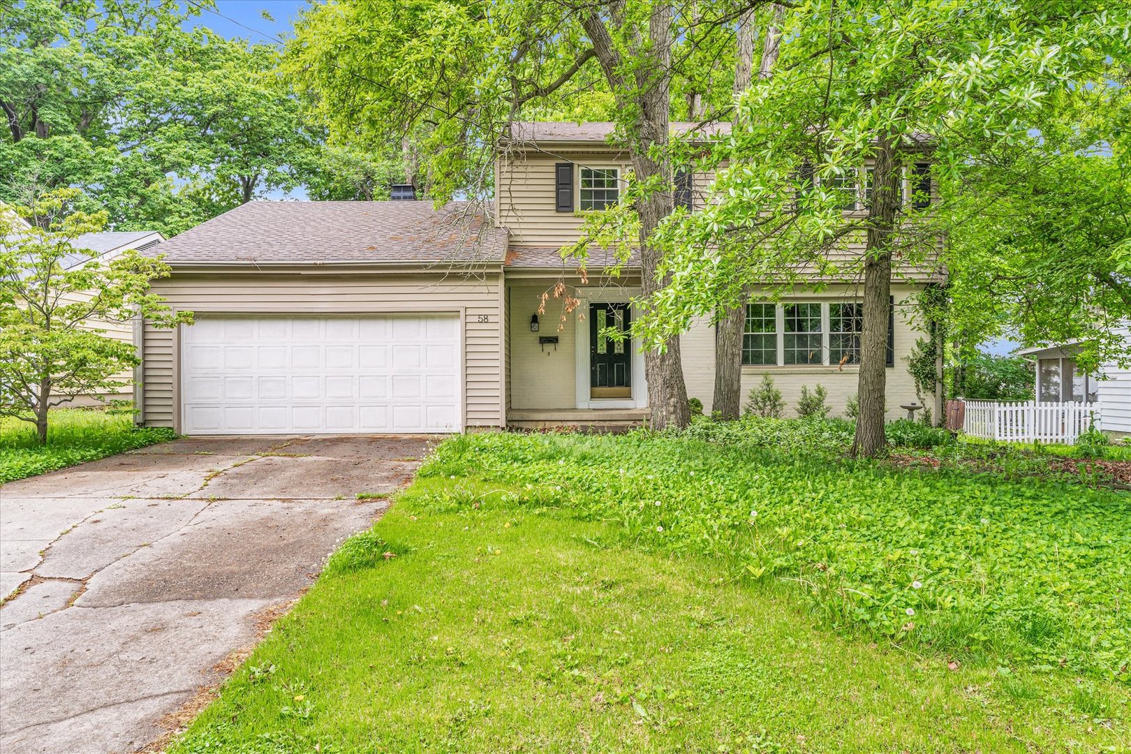 58 Woodhill Court Decatur, IL 62521 - Photo 2 of 29 a front view of a house with a garden and yard
