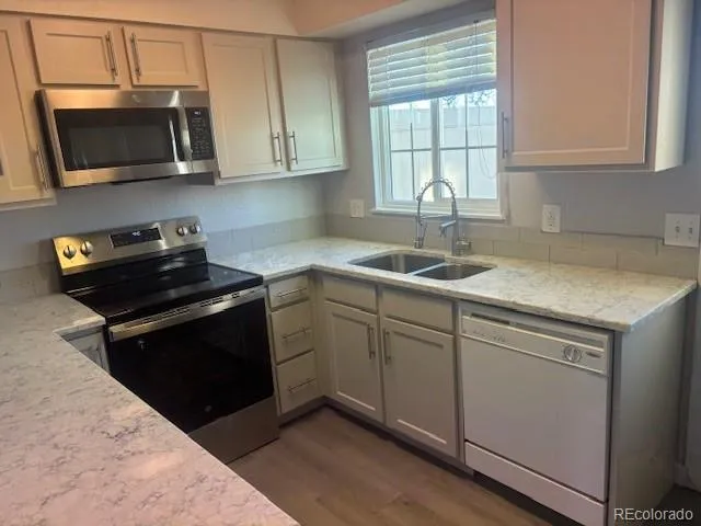 a kitchen with a sink stove and microwave