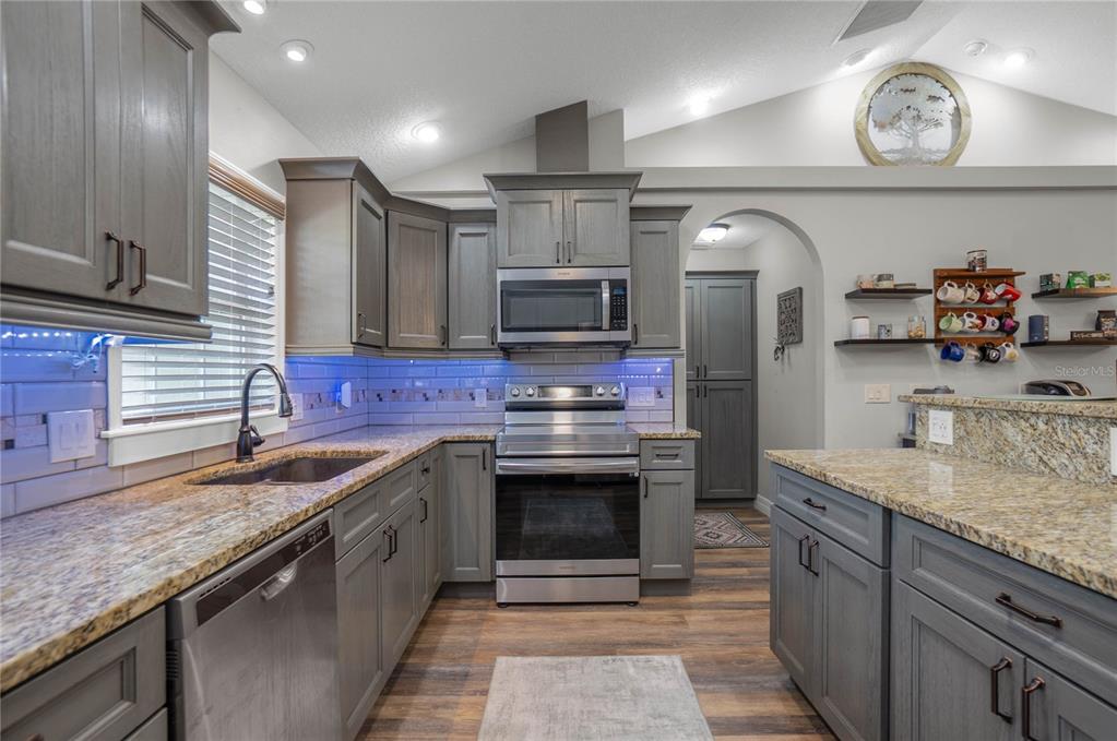 5466 West Tortuga Loop Lecanto, FL 34461 - Photo 12 of 41 a kitchen with stainless steel appliances granite countertop a sink and a stove