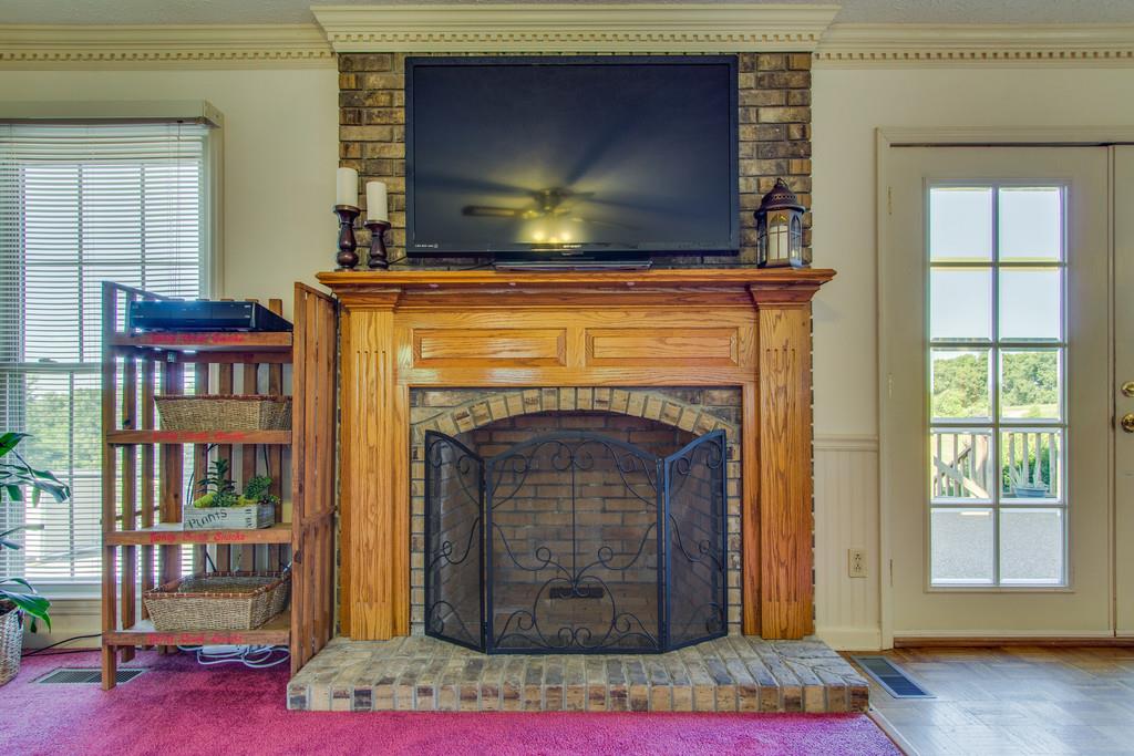 2352 Tom Fitzgerald Road Columbia, TN 38401 - Photo 14 of 30 a living room with a fireplace and a flat screen tv