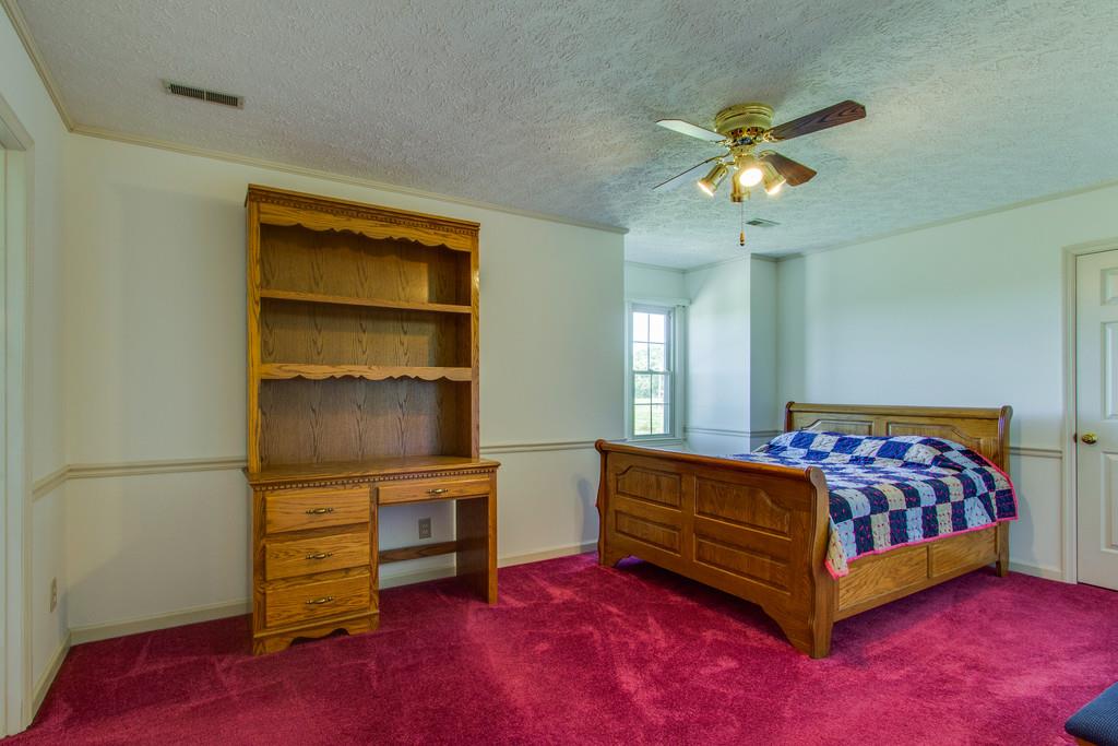 2352 Tom Fitzgerald Road Columbia, TN 38401 - Photo 20 of 30 a bedroom with a bed and a chandelier