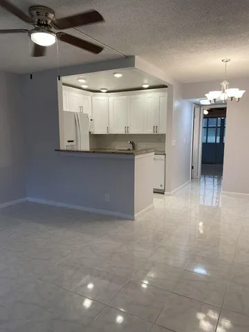 a open kitchen with a sink dishwasher a refrigerator and a fireplace