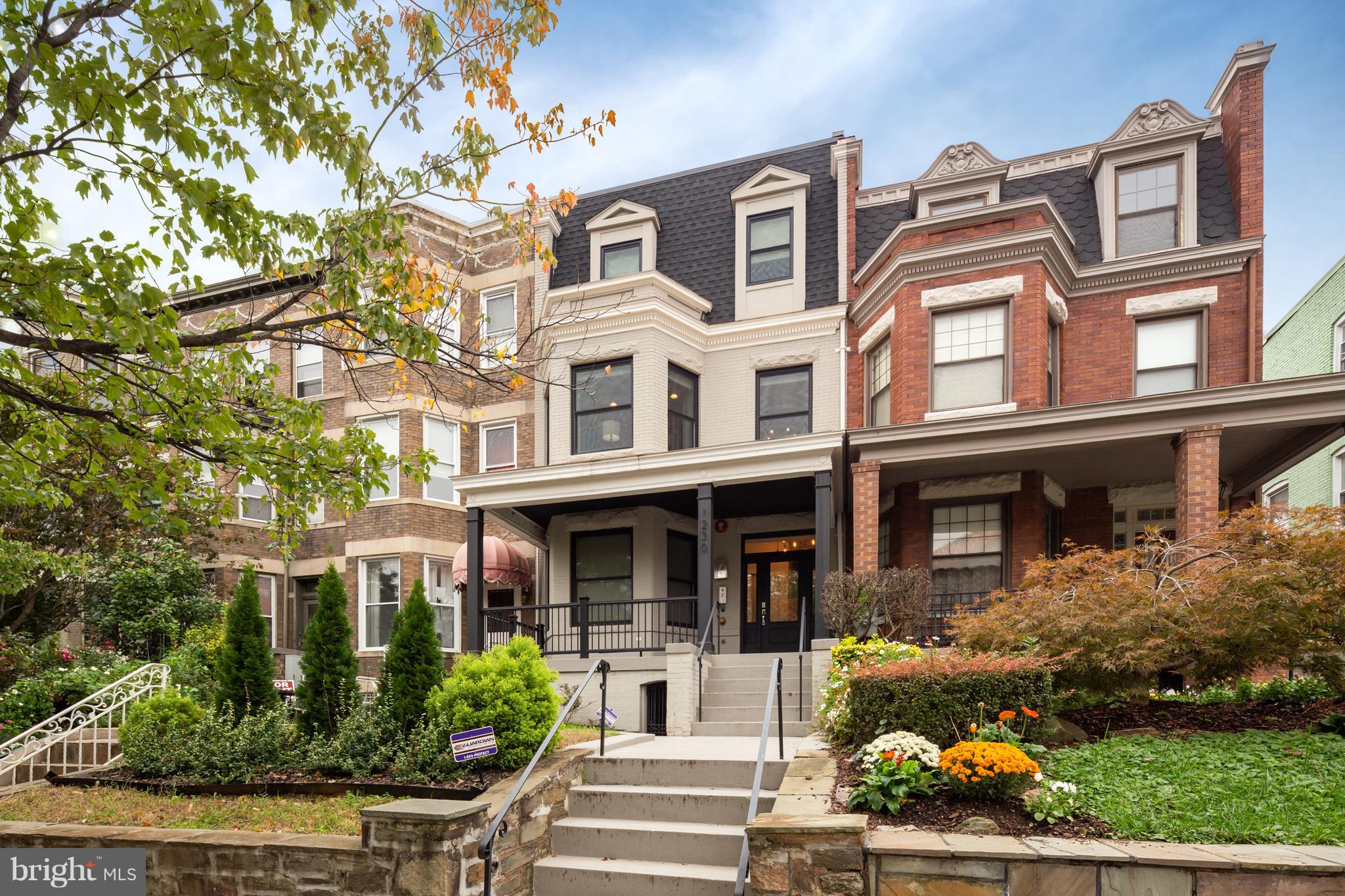 front view of a brick house with a yard