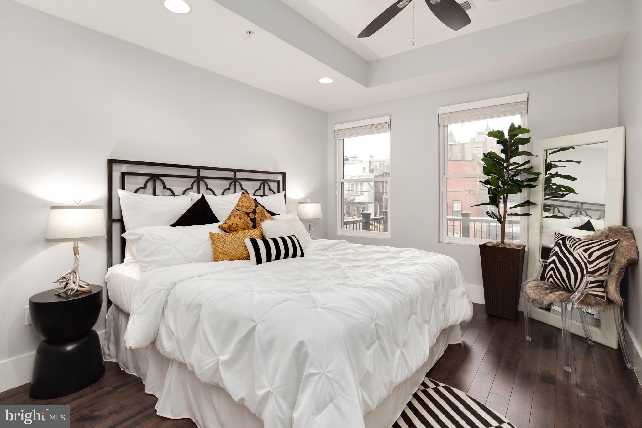 1230 Fairmont Street Northwest, Unit 2 Washington, DC 20009 - Photo 12 of 21 a bedroom with a bed and a chandelier