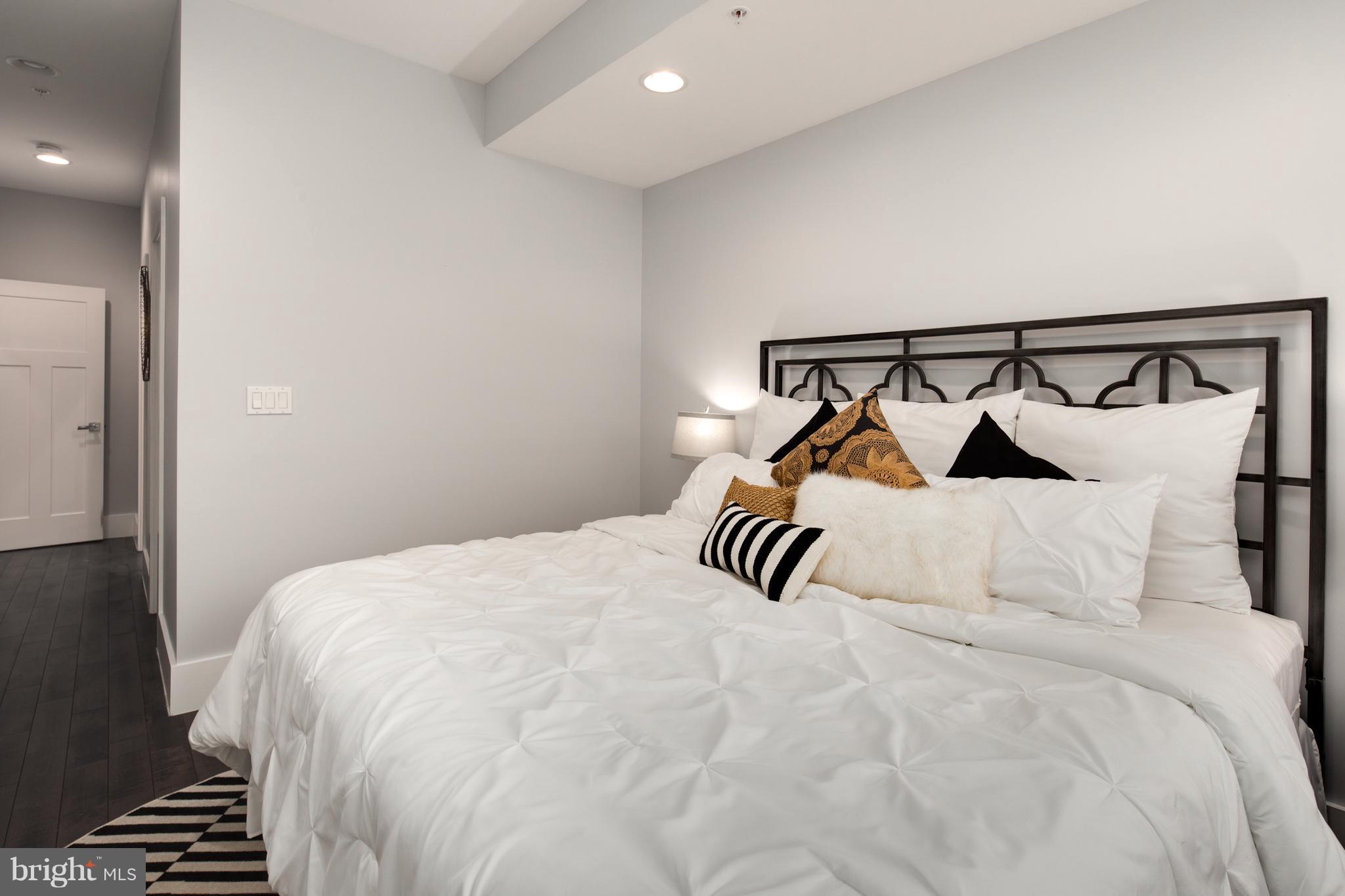 1230 Fairmont Street Northwest, Unit 2 Washington, DC 20009 - Photo 13 of 21 a bedroom with a bed and a night stand
