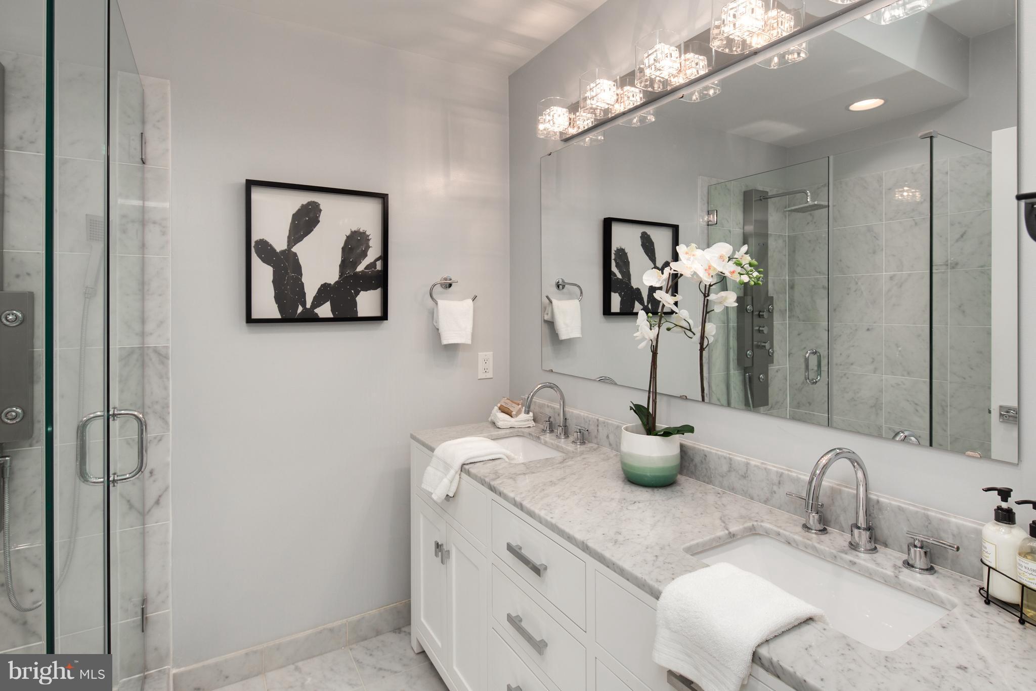 1230 Fairmont Street Northwest, Unit 2 Washington, DC 20009 - Photo 15 of 21 a bathroom with double vanity sinks a vanity and a light fixture