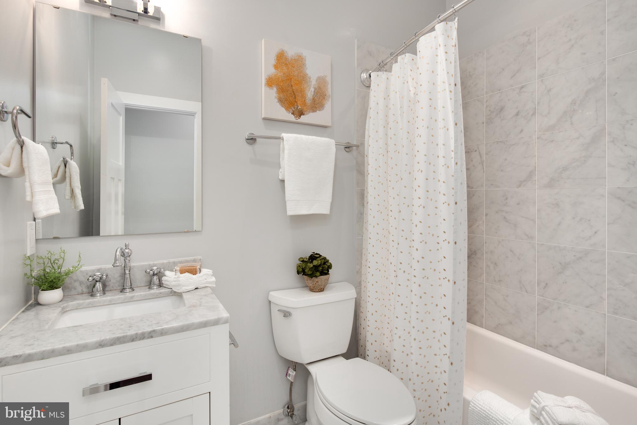 1230 Fairmont Street Northwest, Unit 2 Washington, DC 20009 - Photo 18 of 21 a bathroom with a granite countertop sink and a mirror