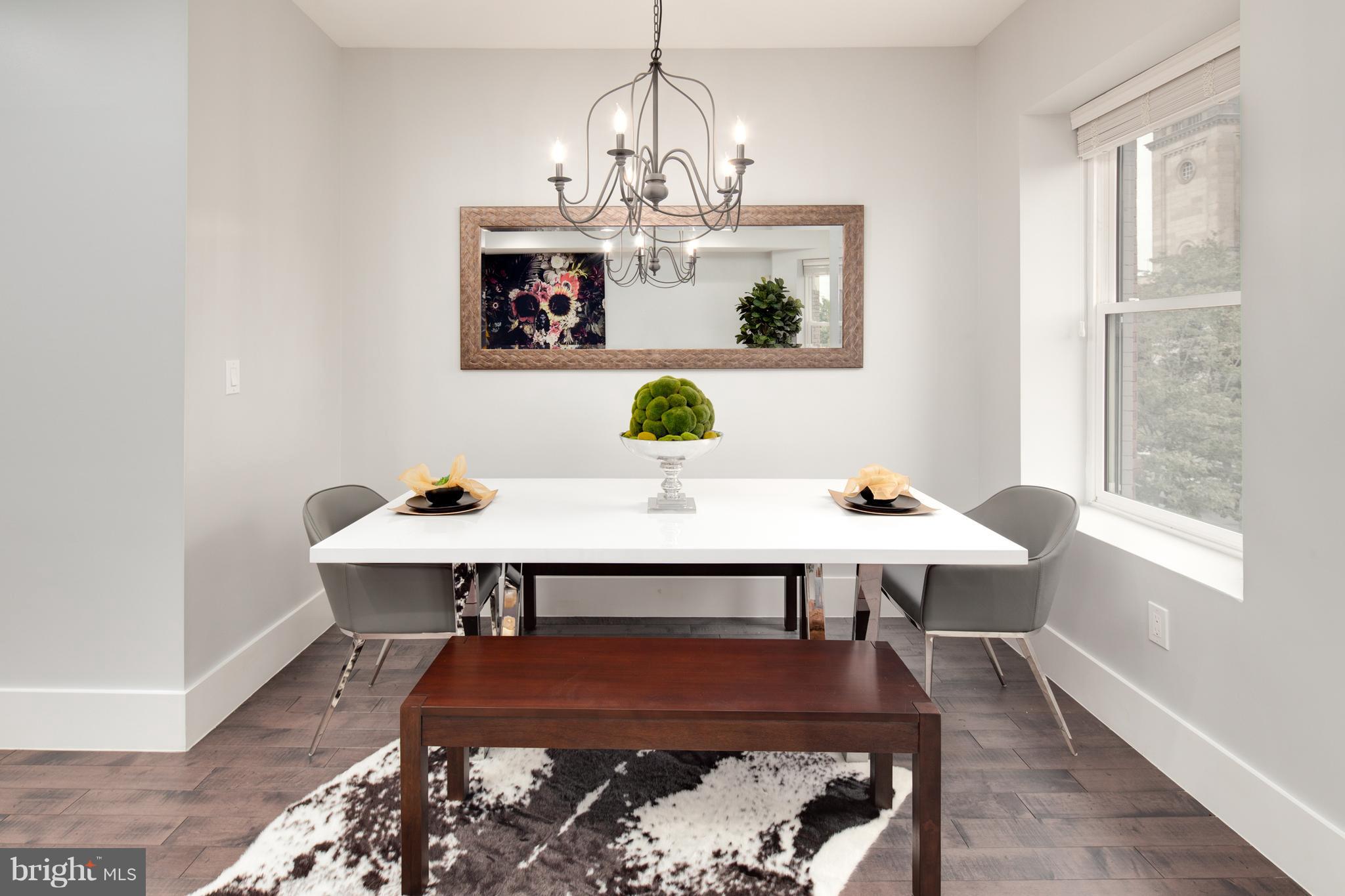 1230 Fairmont Street Northwest, Unit 2 Washington, DC 20009 - Photo 7 of 21 a view of a dining room with furniture a chandelier and wooden floor