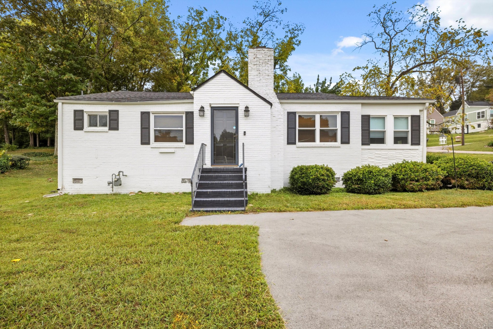 a front view of a house with a yard and porch