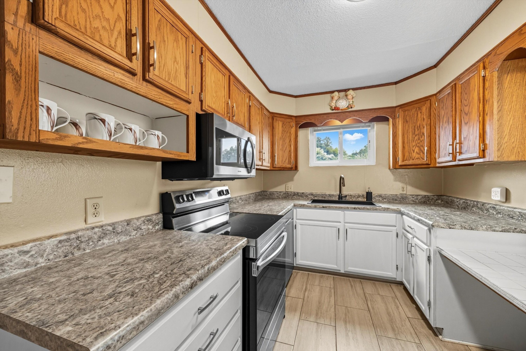 520 Bacon Trail Chattanooga, TN 37412 - Photo 9 of 23 a kitchen with stainless steel appliances granite countertop a stove a sink and a microwave