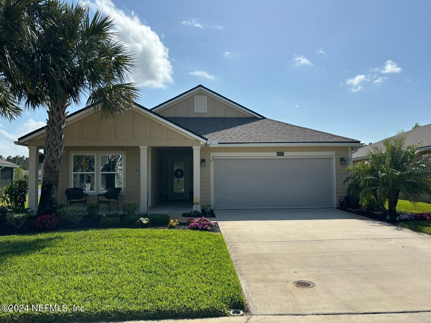 a front view of house with yard and green space