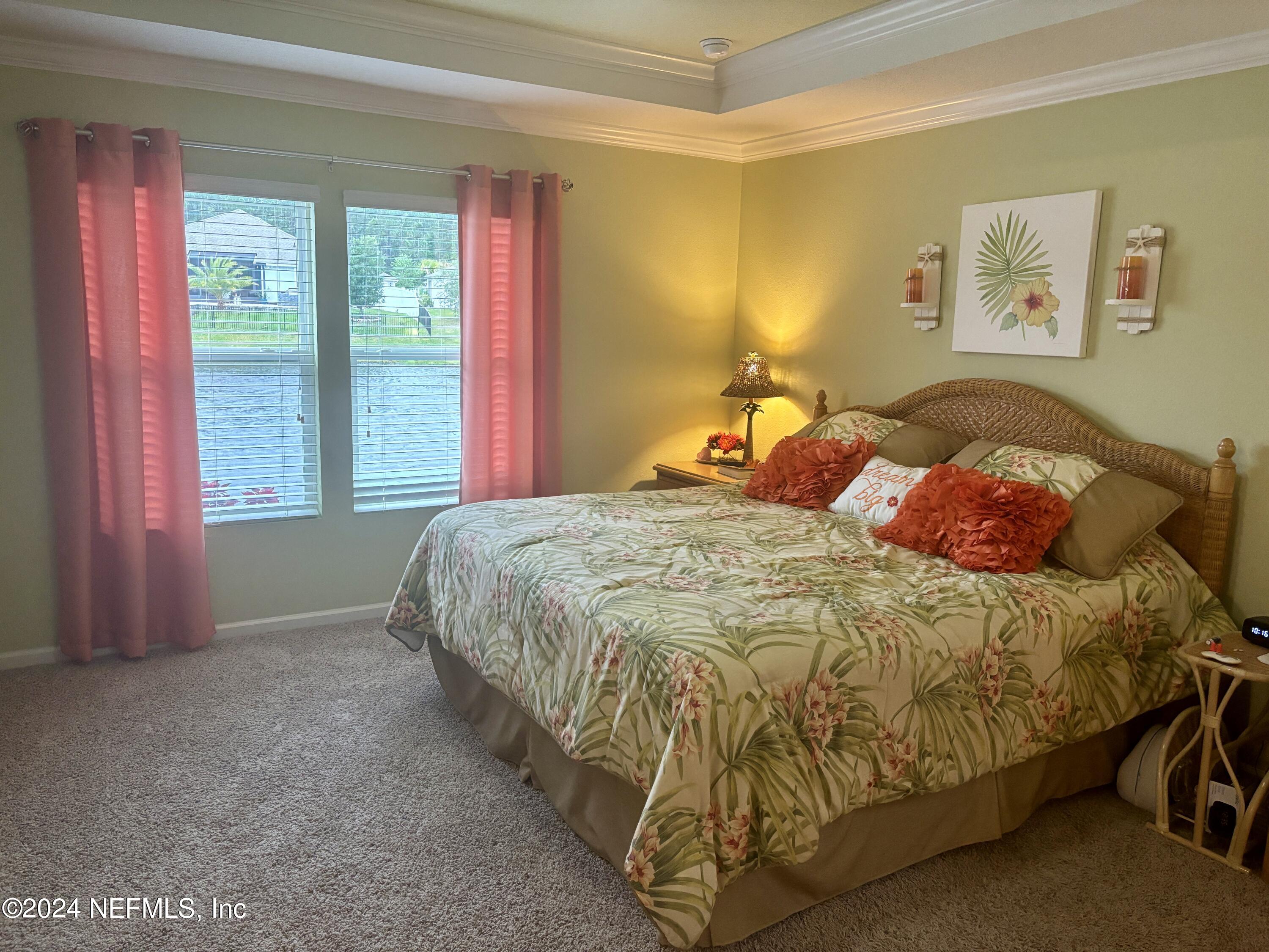 277 Palace Drive St. Augustine, FL 32084 - Photo 12 of 36 a bed sitting in a bedroom next to a window