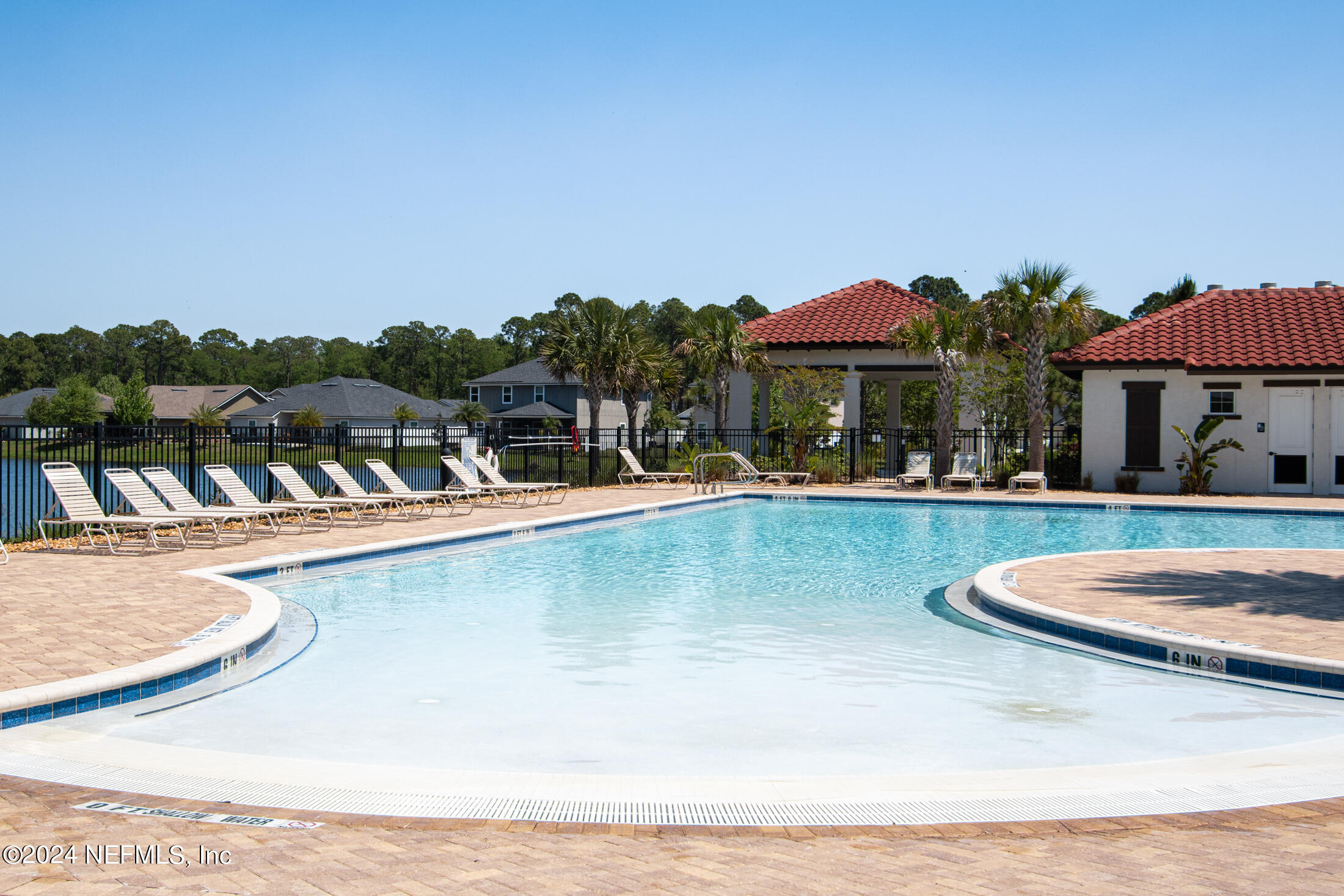 277 Palace Drive St. Augustine, FL 32084 - Photo 20 of 36 a view of a swimming pool with a table and chairs under an umbrella