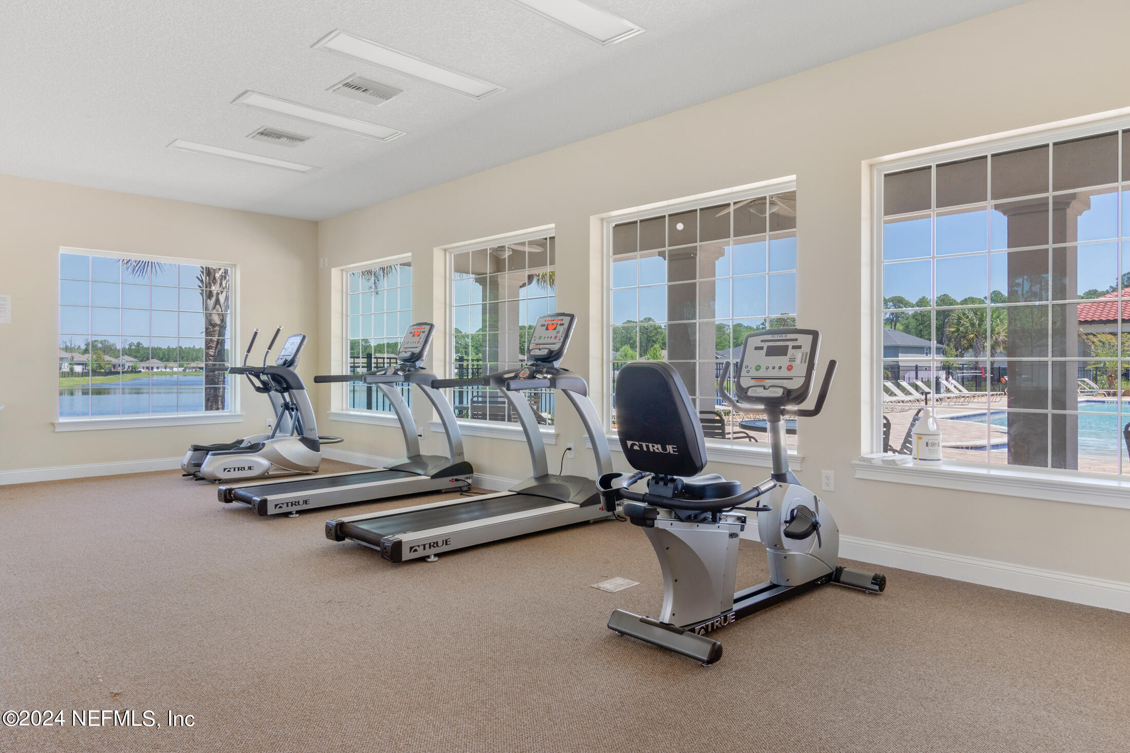 277 Palace Drive St. Augustine, FL 32084 - Photo 27 of 36 a room with gym equipment and floor to ceiling window