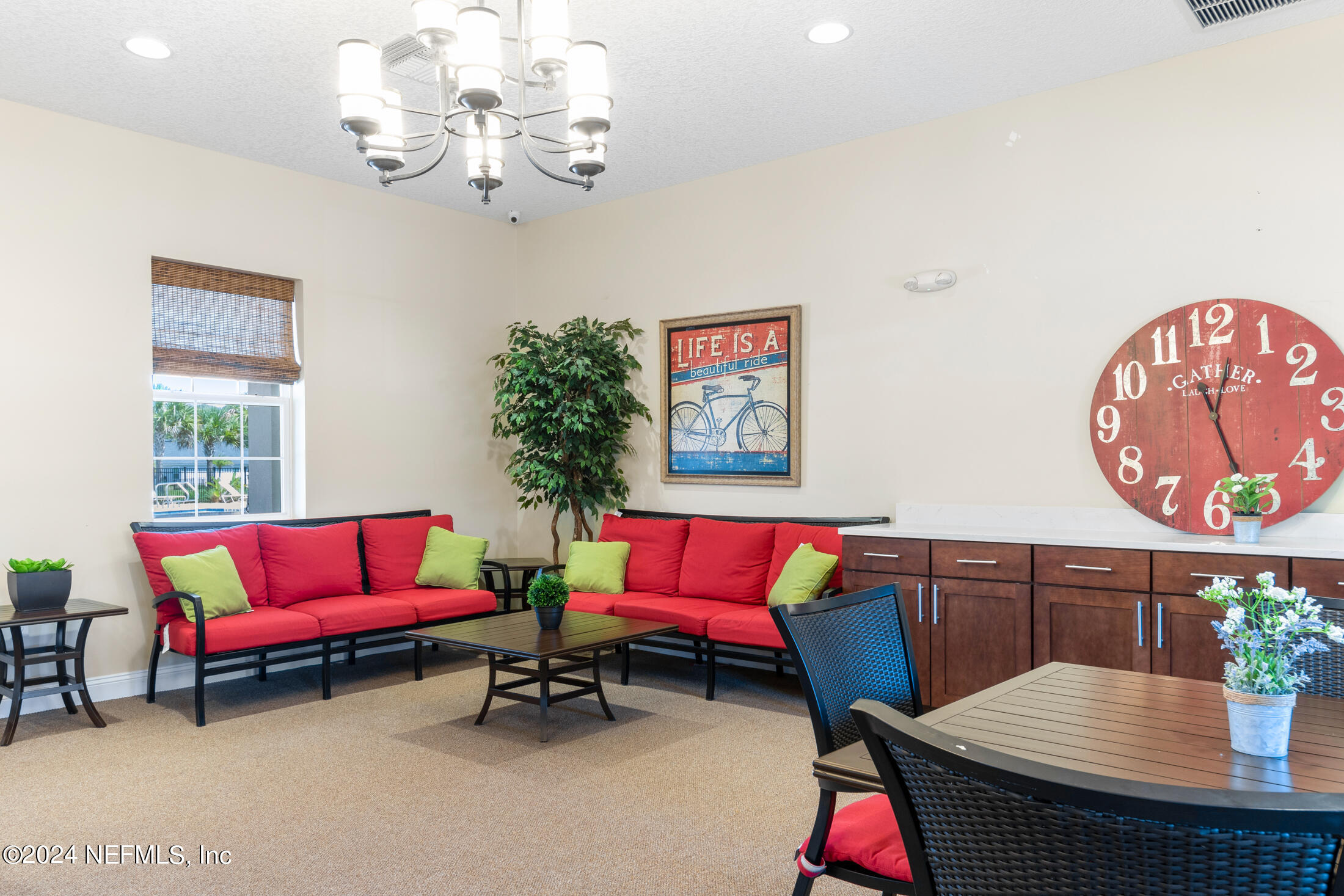 277 Palace Drive St. Augustine, FL 32084 - Photo 30 of 36 a living room with furniture and a chandelier