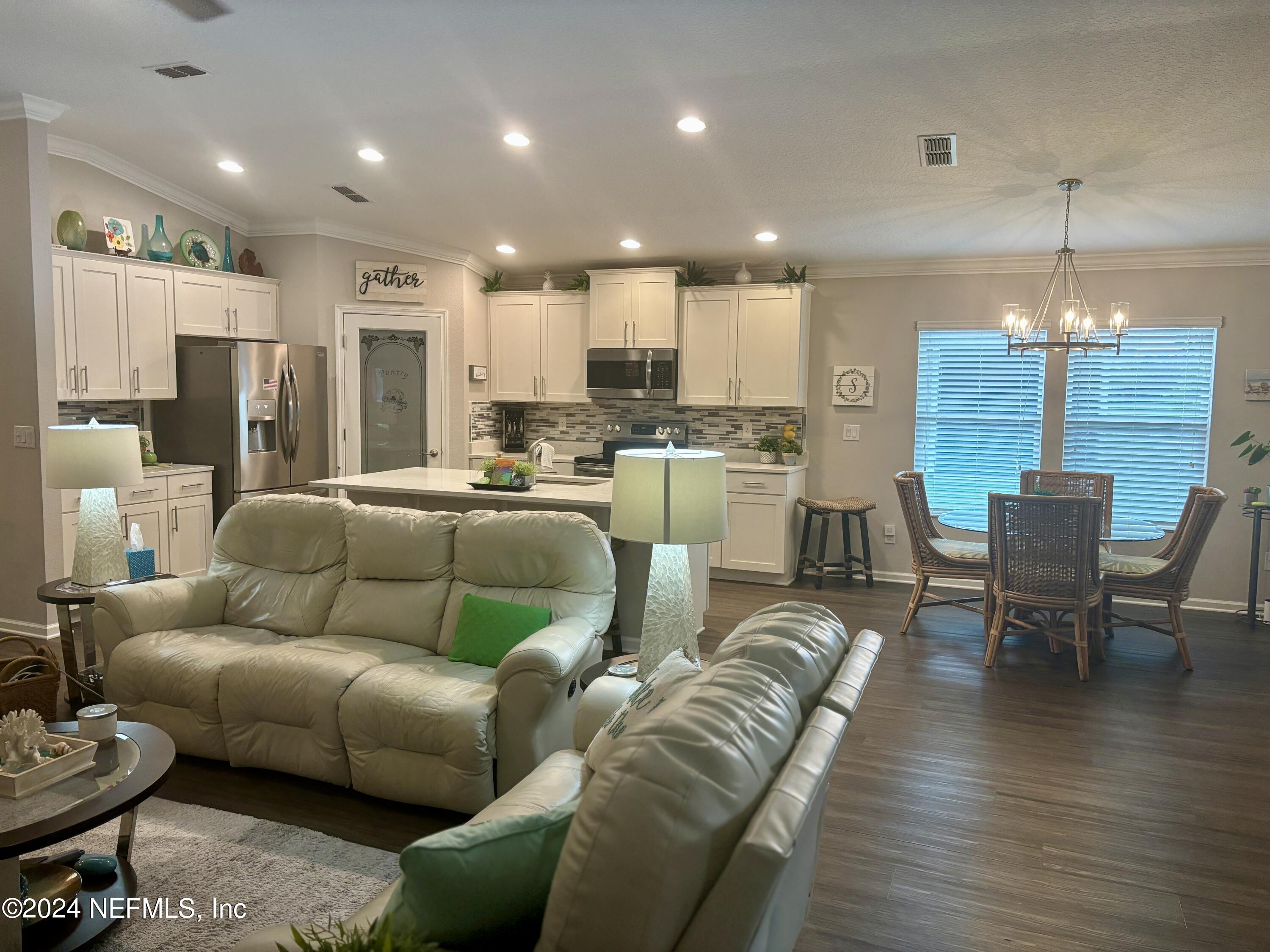 277 Palace Drive St. Augustine, FL 32084 - Photo 7 of 36 a living room with furniture kitchen and a chandelier