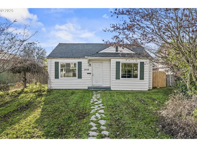 a aerial view of a house with a yard and potted plants