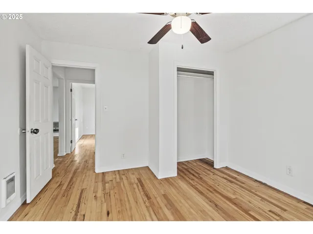 a view of an empty room and wooden floor