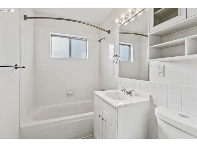 a bathroom with a sink mirror and a bathtub