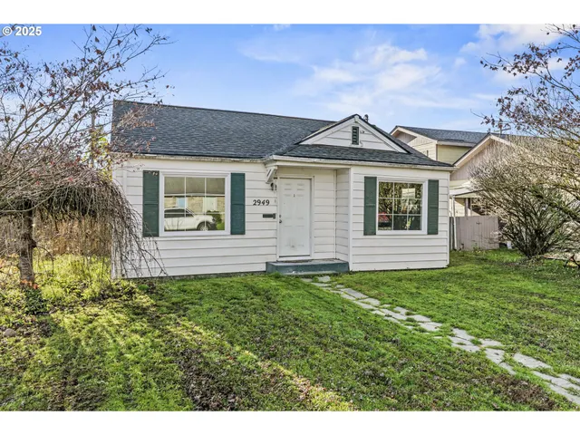 a view of a house with a small yard and a large window