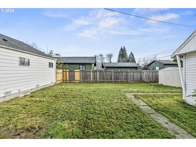 a view of a house with a backyard