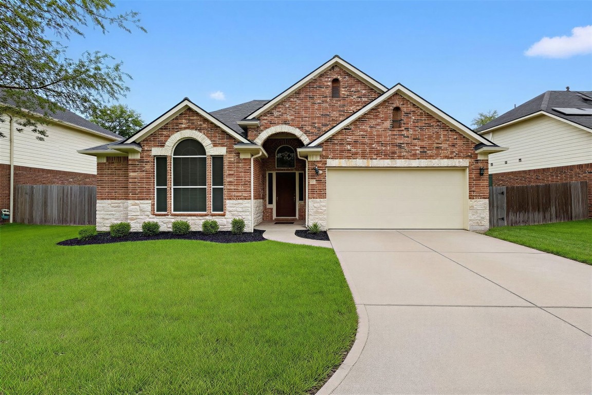 Front Exterior (Enhanced Landscaping View)
Beautifully maintained front elevation featuring fresh landscaping, arched architectural details, and a