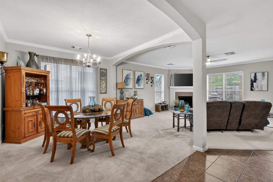 25710 Crisp Spring Lane Spring, TX 77373 - Photo 12 of 37 Living Room (Wide Angle)
Expansive living area featuring a cozy fireplace, large windows, and open sightlines to dining spaces.