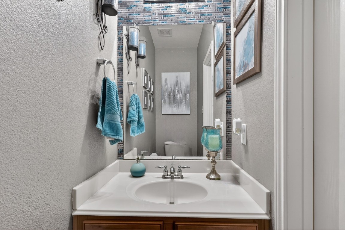 25710 Crisp Spring Lane Spring, TX 77373 - Photo 15 of 37 Half Bathroom (Powder Room)
Stylish powder bath featuring a modern framed mirror, decorative tile accent, and fresh neutral tones—perfectly positioned for guests.