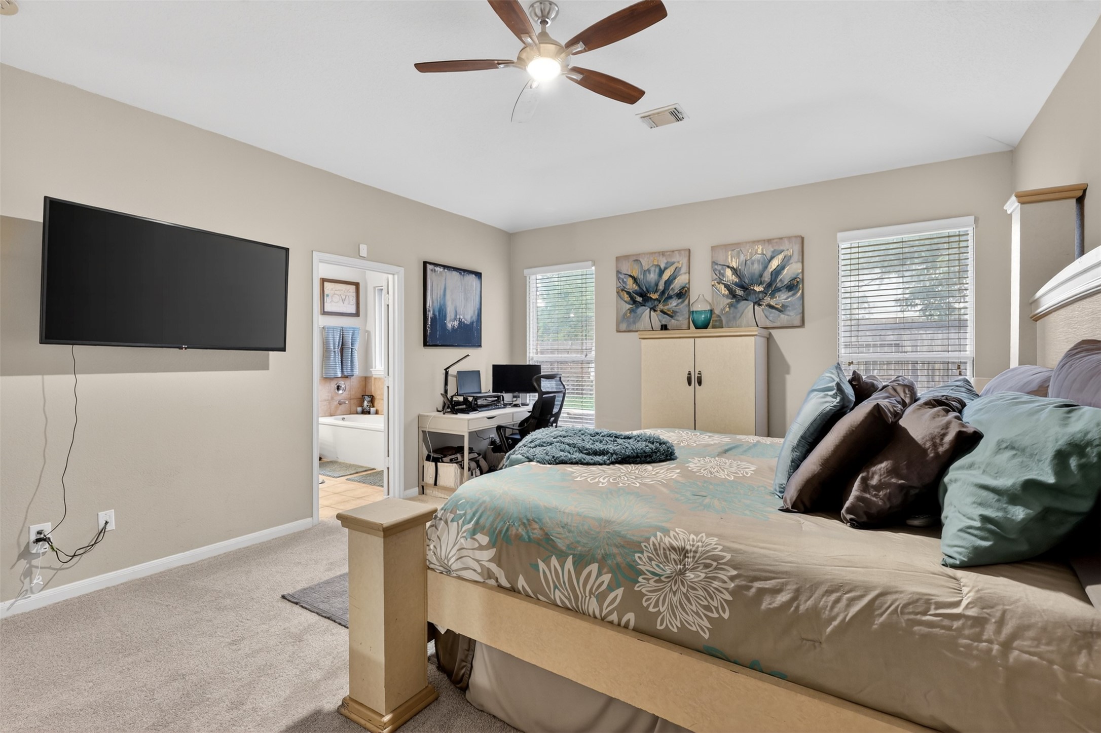 25710 Crisp Spring Lane Spring, TX 77373 - Photo 20 of 37 Primary Bedroom (View 2)
Alternate view of the primary bedroom showcasing ample space for a sitting area or workspace, plus easy access to the ensuite bath.