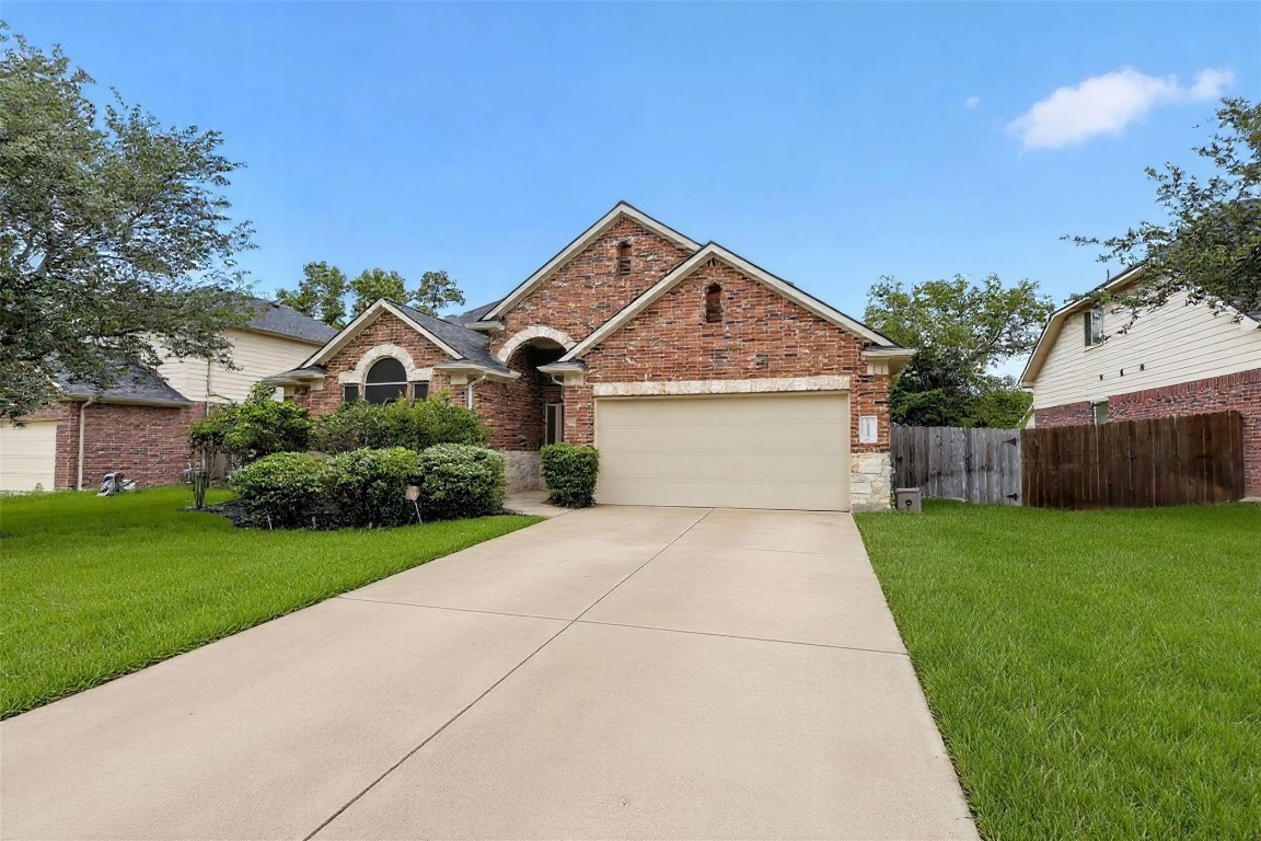 25710 Crisp Spring Lane Spring, TX 77373 - Photo 2 of 37 Front Exterior (Wide Driveway View)
Spacious driveway leads to a charming brick façade with mature landscaping and inviting curb appeal.