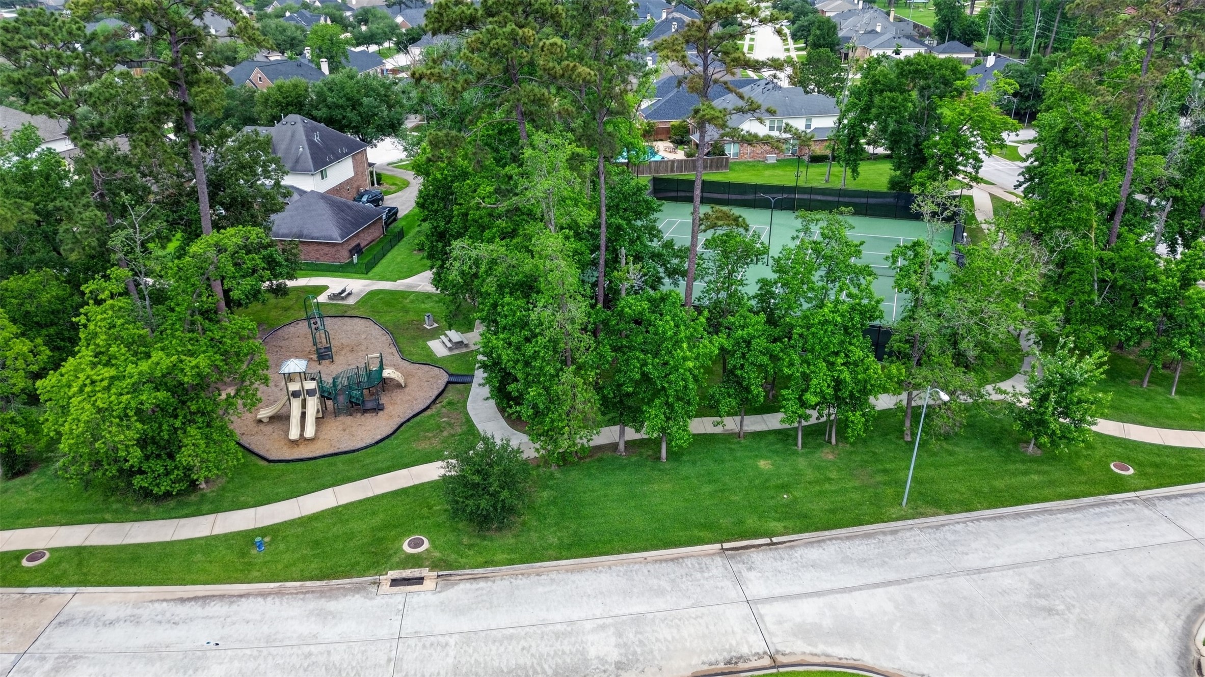 25710 Crisp Spring Lane Spring, TX 77373 - Photo 32 of 37 Community Park & Tennis Courts (Aerial)
Aerial view of neighborhood amenities including tennis courts, walking trails, and a playground.
