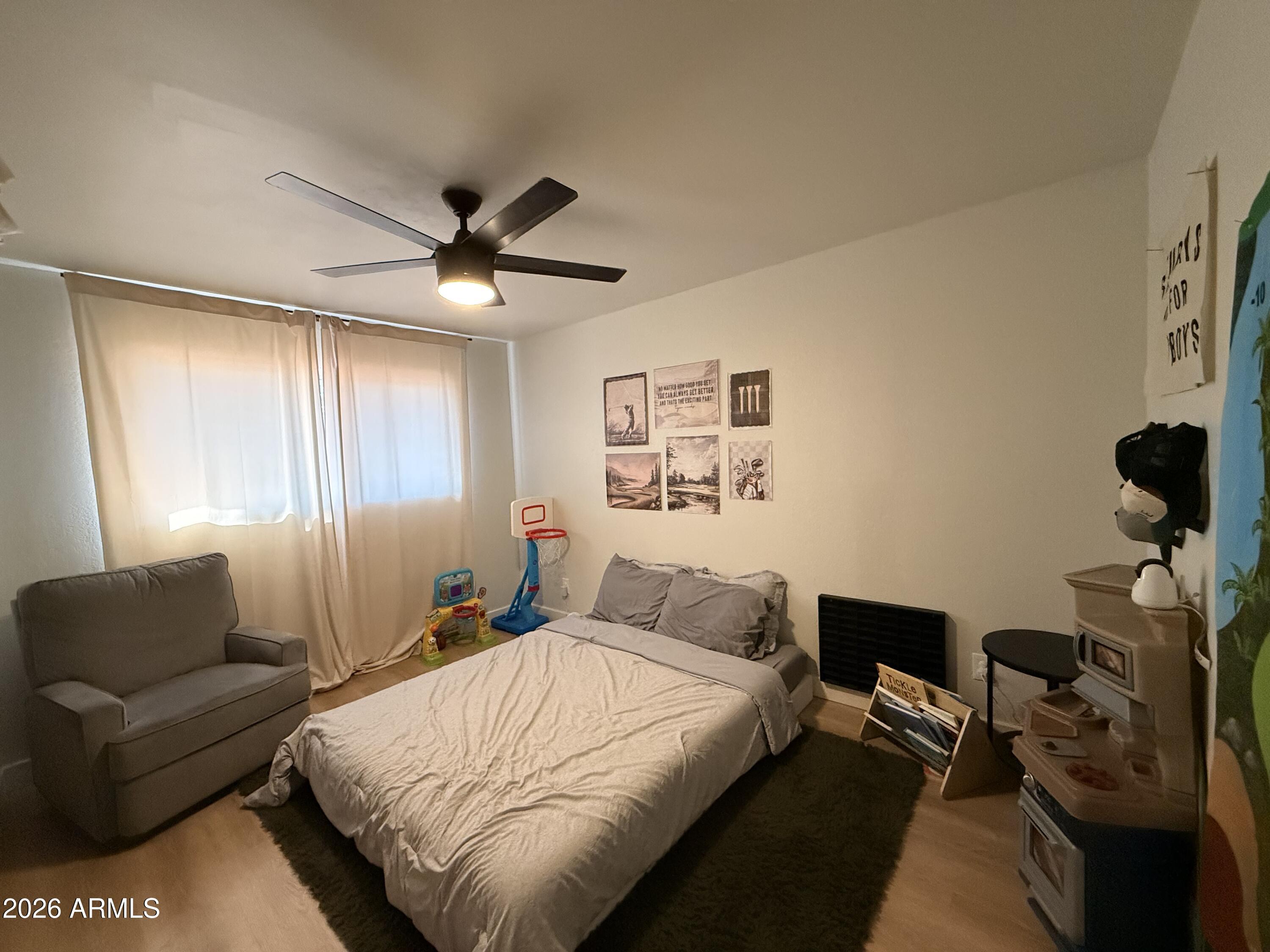 1744 North Ridge Circle Mesa, AZ 85203 - Photo 12 of 14 a bedroom with a bed couch and window