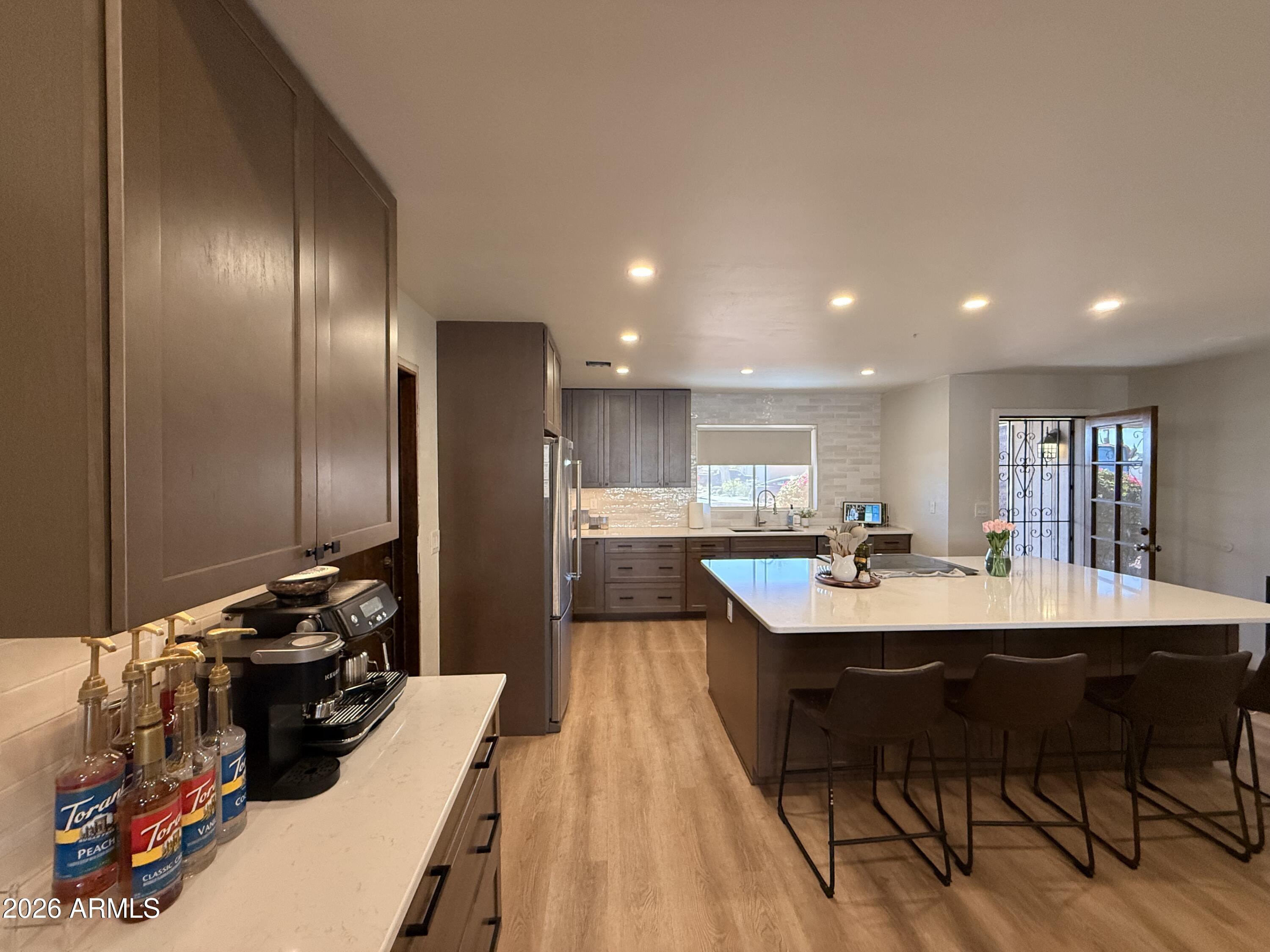 1744 North Ridge Circle Mesa, AZ 85203 - Photo 4 of 14 a kitchen with a sink and chairs