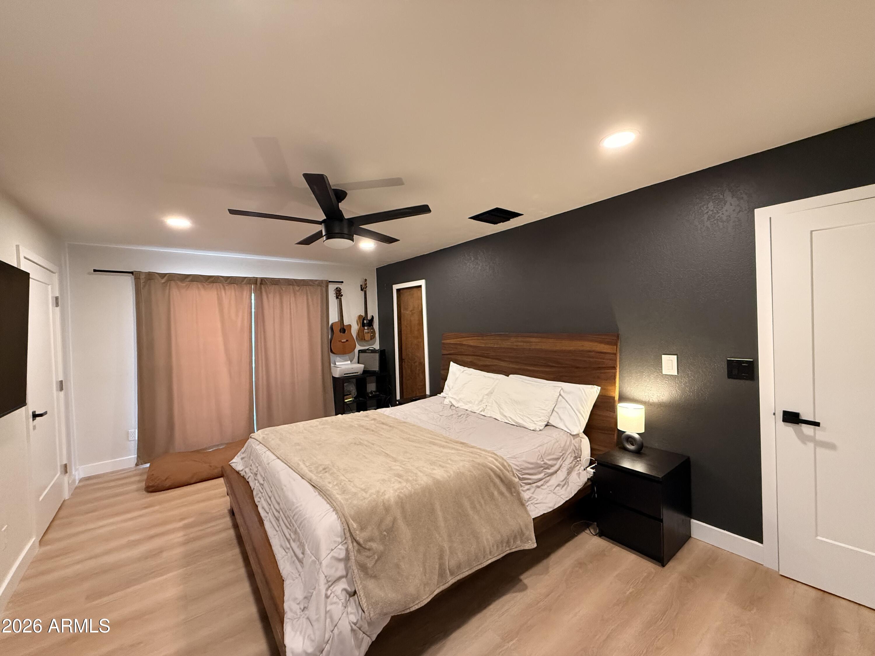 1744 North Ridge Circle Mesa, AZ 85203 - Photo 8 of 14 a bedroom with a bed and a flat tv screen on dresser