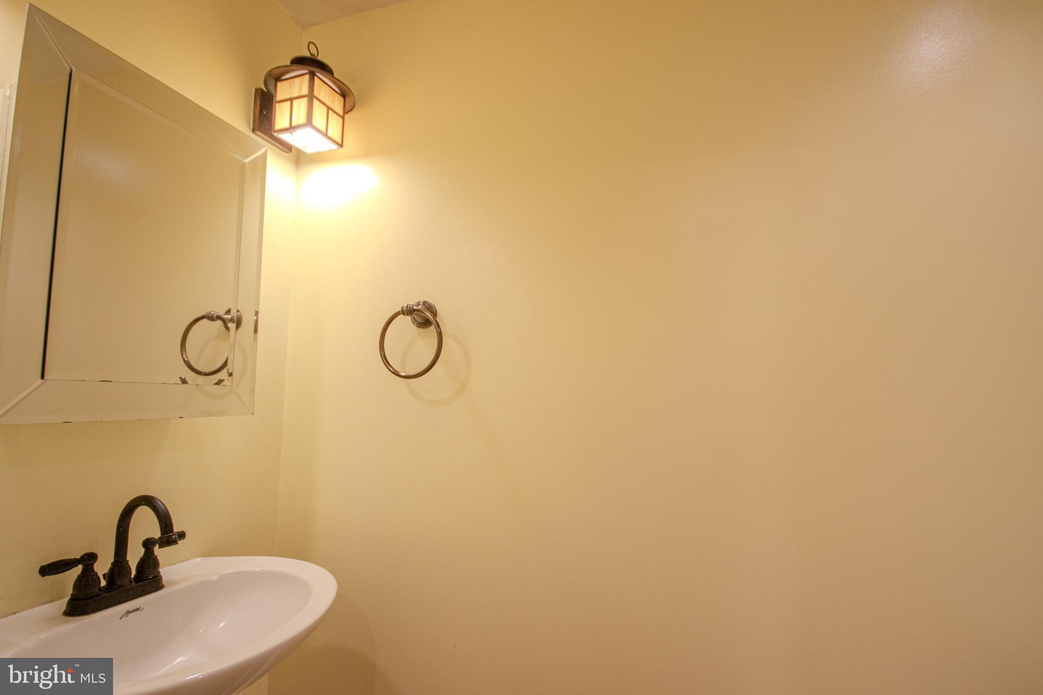 224 West Main Street, Unit 203 Salisbury, MD 21801 - Photo 10 of 20 a bathroom with a sink and mirror