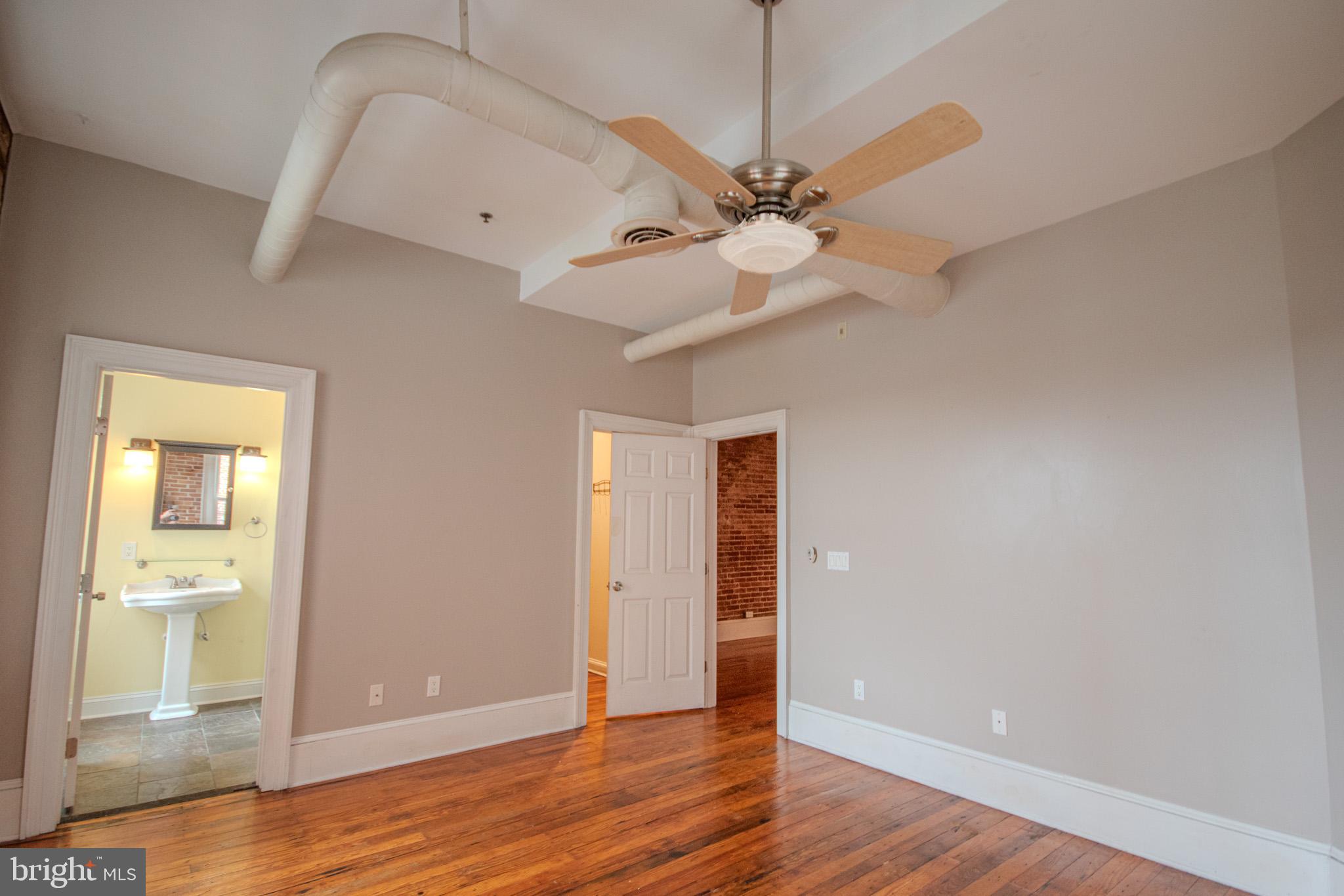 224 West Main Street, Unit 203 Salisbury, MD 21801 - Photo 13 of 20 wooden floor in an empty room with a window