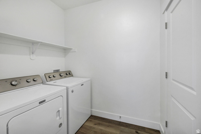 3115 South 200 West, Unit C201 Nibley, UT 84321 - Photo 16 of 23 Dedicated laundry area featuring a white floating shelf, neutral white walls, white baseboards, and wood-finish flooring