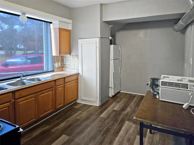 a kitchen with stainless steel appliances a refrigerator and a stove top oven