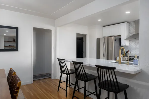 a view of a dining room with furniture and wooden floor