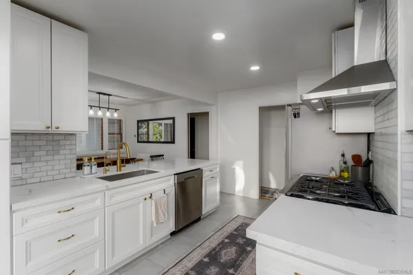 a kitchen with a sink stove and cabinets