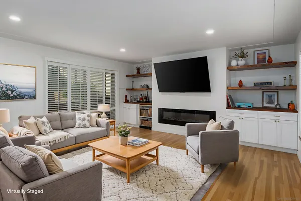 a living room with fireplace furniture and a flat screen tv